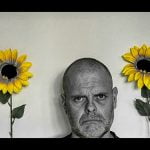 unhappy man with sunflowers