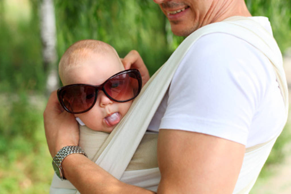 man with child in baby carrier