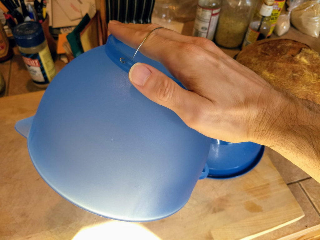hand holding dough proofing bowl with homemade handle
